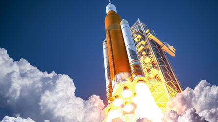 A spacecraft launches amidst clouds of smoke, showcasing its vibration and shock resistance during liftoff.