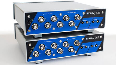 Two stacked m+p VibPilot devices feature multiple input and output ports for precise vibration testing.