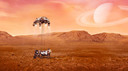 A spacecraft deploys a rover onto a rocky, reddish planet under a sky with a large ringed planet in the background.