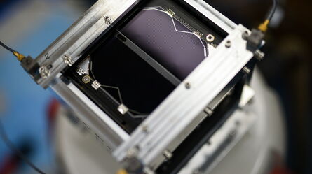 A close-up of a metallic apparatus featuring intricate wiring and components, capturing the essence of advanced technology.