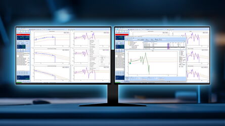 A dual monitor setup displays complex graphs and data analysis, enhancing productivity in a dimly lit workspace.