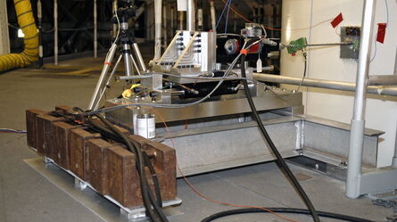 Industrial equipment setup with a camera and cables on a platform, indicating a technical or experimental process.