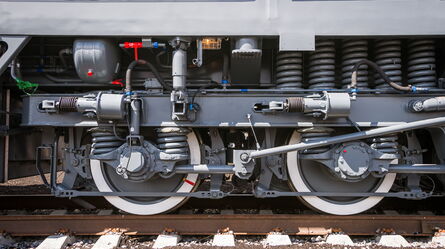 A detailed view of a train's wheel assembly showcases its compliance and certification testing features.