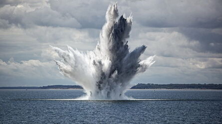 A massive water explosion erupts dramatically from the ocean, creating an impressive display of shock and vibration.